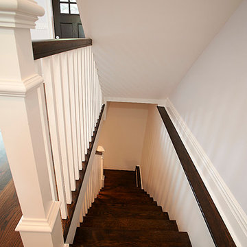 Modern Staircase with Dark Wood Steps and White Railings