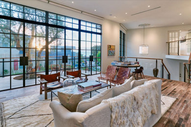 Living room - large contemporary formal and open concept light wood floor and brown floor living room idea in San Diego with white walls, a standard fireplace, a plaster fireplace and no tv
