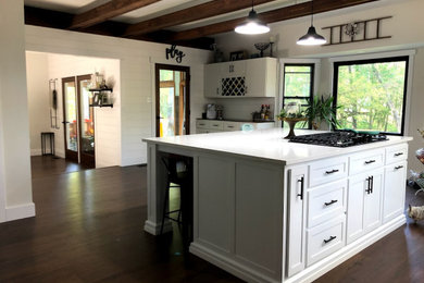 Inspiration for a kitchen remodel in Philadelphia with white cabinets and an island