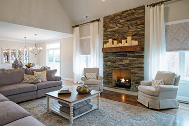 Example of an arts and crafts open concept dark wood floor living room design in Other with gray walls, a standard fireplace and a stone fireplace