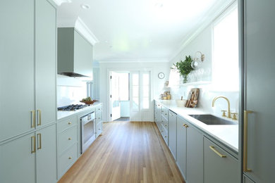 Enclosed kitchen - small contemporary galley enclosed kitchen idea in Vancouver with an undermount sink, gray cabinets, quartz countertops, white backsplash, stone slab backsplash, no island and white countertops