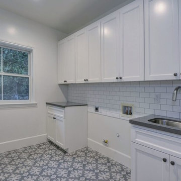 Spanish contemporary - laundry room with geometric tile floor