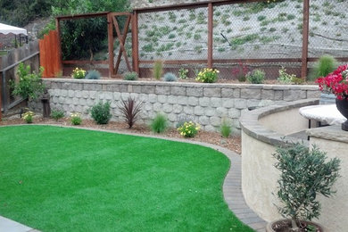 Inspiration for a large tropical partial sun front yard stone driveway in San Diego.