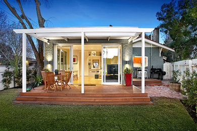 Small contemporary patio in Melbourne with decking and a pergola.