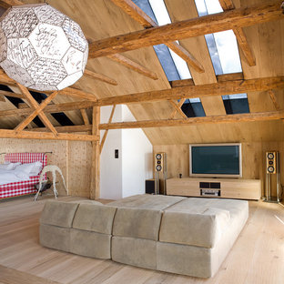 Medium sized rustic open plan home cinema in Other with a wall mounted tv, brown walls and light hardwood flooring.