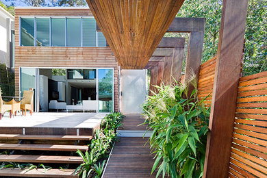 Photo of a contemporary backyard deck in Brisbane with a roof extension.