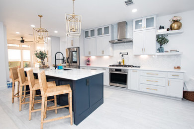 Eat-in kitchen - porcelain tile and white floor eat-in kitchen idea in Austin with a single-bowl sink, shaker cabinets, white cabinets, marble countertops, white backsplash, marble backsplash, stainless steel appliances, an island and white countertops