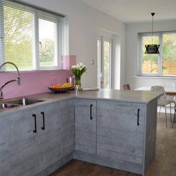 Textured concrete effect kitchen with baby pink accents