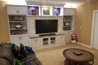 Basement - mid-sized transitional underground carpeted and beige floor basement idea in Other with brown walls
