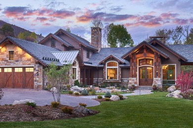 Example of a large classic multicolored two-story mixed siding house exterior design in Denver with a tile roof