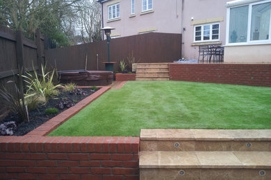 Medium sized modern back garden for summer in Other with natural stone paving.