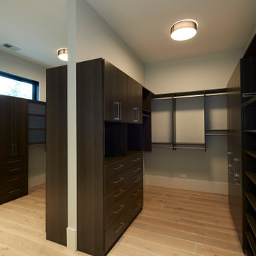 Custom Walk-In Closet with Sleek Dark Cabinetry and Optimized Storage