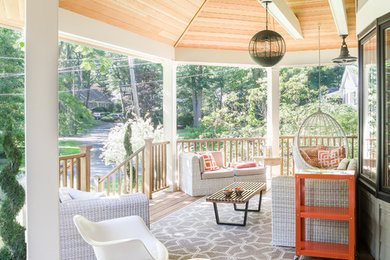 Transitional front porch idea in New York with decking and a roof extension