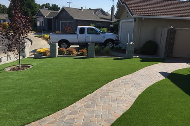 This is an example of a drought-tolerant and full sun front yard concrete paver garden path in San Francisco.