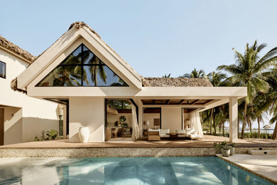 Island style white two-story concrete exterior home photo