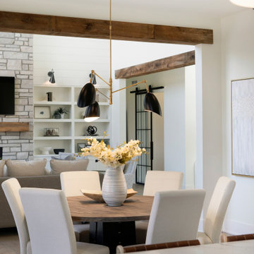 Weathered Antique Box Beams Framing a Dining Room to Living Room Transition