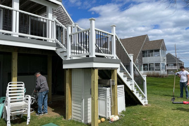 Large beach style backyard second story mixed material railing deck photo in Providence
