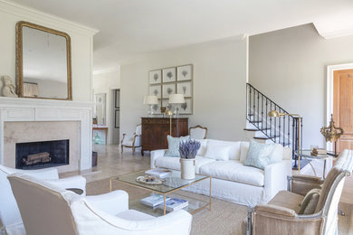 Inspiration for a mid-sized transitional formal enclosed living room in New Orleans with white walls, limestone floors, a standard fireplace, a stone fireplace surround, no tv and beige floor.