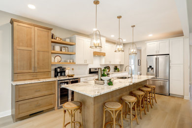 Eat-in kitchen - mid-sized contemporary single-wall vinyl floor and beige floor eat-in kitchen idea in Philadelphia with an undermount sink, shaker cabinets, white cabinets, granite countertops, white backsplash, ceramic backsplash, stainless steel appliances, an island and brown countertops