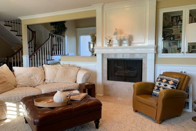 Example of a mid-sized classic enclosed carpeted and beige floor living room design in Orange County with beige walls, a standard fireplace and a stone fireplace