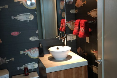 Example of a transitional powder room design in Portland with flat-panel cabinets, medium tone wood cabinets, a one-piece toilet, beige walls and quartz countertops