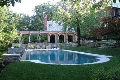 Large elegant backyard concrete paver and rectangular infinity pool fountain photo in St Louis