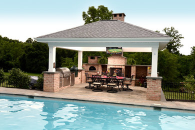 Patio - mid-sized traditional backyard stone patio idea in Baltimore with a fireplace and a pergola
