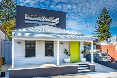 Photo of a small contemporary two-storey white exterior in Perth.
