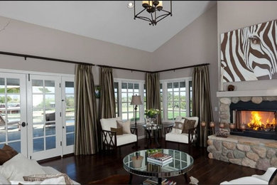 Inspiration for a large transitional open concept dark wood floor living room remodel in Santa Barbara with a standard fireplace, a stone fireplace and no tv