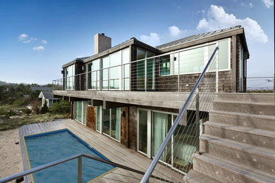 Deck - large coastal backyard deck idea in New York