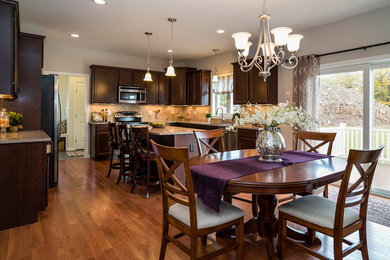 Example of a classic u-shaped dark wood floor eat-in kitchen design in Bridgeport with an undermount sink, quartzite countertops, beige backsplash, ceramic backsplash, stainless steel appliances and an island