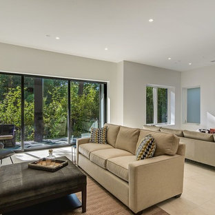 Foto de sótano con puerta moderno, grande, con paredes blancas, suelo de piedra caliza, chimenea tradicional, marco de chimenea de piedra y suelo beige