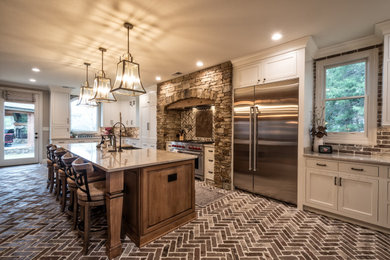 Kitchen - rustic brick floor kitchen idea in Other with quartzite countertops, brick backsplash, stainless steel appliances and an island