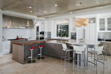 Large transitional kitchen in Orange County with a single-bowl sink, flat-panel cabinets, white cabinets, granite benchtops, white splashback, mosaic tile splashback, stainless steel appliances, ceramic floors and multiple islands.