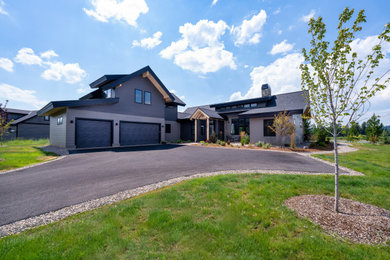 Example of a classic gray two-story metal exterior home design in Boise with a shingle roof, a black roof and a hip roof