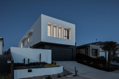 Mid-sized modern two-storey white house exterior in Gold Coast - Tweed with mixed siding, a flat roof and a metal roof.