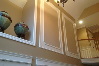 Elegant foyer photo in New York with beige walls