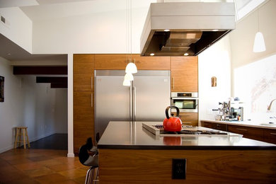 Inspiration for a mid-sized contemporary l-shaped terra-cotta tile eat-in kitchen remodel in Other with flat-panel cabinets, medium tone wood cabinets, stainless steel appliances, an island, an undermount sink and granite countertops