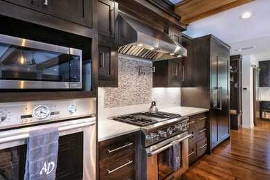 Inspiration for a mid-sized contemporary single-wall medium tone wood floor open concept kitchen remodel in Indianapolis with dark wood cabinets, quartzite countertops, gray backsplash, mosaic tile backsplash, stainless steel appliances, an island and shaker cabinets