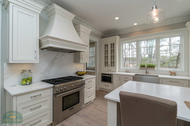 Example of a mid-sized trendy u-shaped kitchen design in Boston with shaker cabinets, white cabinets, gray backsplash, marble backsplash, stainless steel appliances and an island