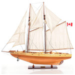 Old Modern Handicraft - Bluenose II Fully Assembled Boat Model Display - This is a beautiful FULLY ASSEMBLED Bluenose II in natural wood finish. It has wooden booms connected to the main and foremast. All the sails are rigged beautifully together to make up the beautiful boat. On the deck, there are authentic hand-built lifeboats with ribs and planks. The bowsprit goes through the gunwale that is hold securely to the bow by riggings. Cabins and companionways are located on the wooden deck. You will find metal anchors near the gunwale inside the two golden ornament piece of the Bluenose. This model is truly a remarkable representation of the Bluenose II. Item DIM: 38.5" x 6.5" x 32.75" Item Weight: 5.5 lbs