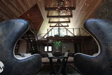 Inspiration for a large rustic loft-style dark wood floor family room remodel in New York with white walls, no tv, a standard fireplace and a stone fireplace