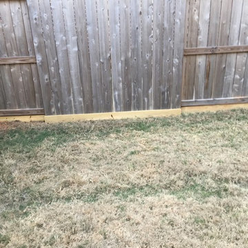 Install boards at the bottom of cedar fence to help keep owners dog in the yard.