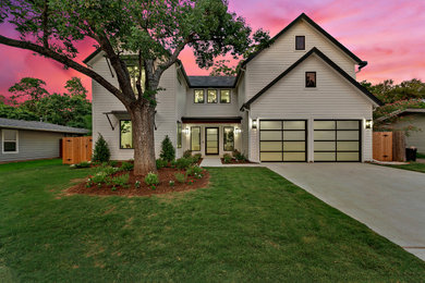 Example of a trendy white two-story house exterior design in Austin with a mixed material roof