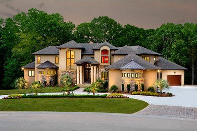 Inspiration for a large mediterranean three-story stucco exterior home remodel in Charlotte