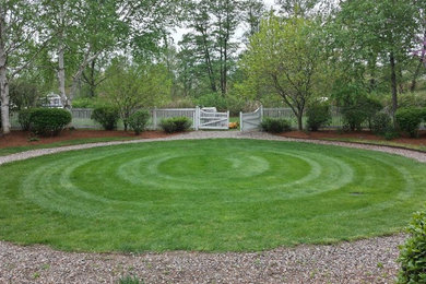 Photo of a large traditional full sun backyard gravel landscaping in Boston.
