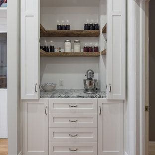 Large farmhouse kitchen pantry inspiration - Large cottage l-shaped light wood floor and brown floor kitchen pantry photo in Ottawa with a farmhouse sink, shaker cabinets, white cabinets, granite countertops, white backsplash, subway tile backsplash, stainless steel appliances and an island