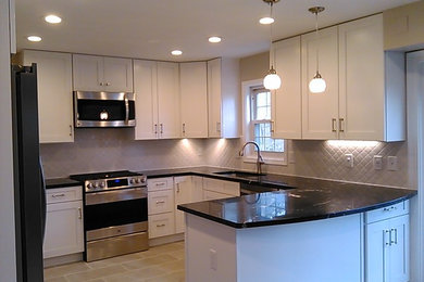 Kitchen - mid-sized transitional u-shaped porcelain tile and beige floor kitchen idea in DC Metro with an undermount sink, shaker cabinets, white cabinets, granite countertops, white backsplash, glass tile backsplash, stainless steel appliances and a peninsula
