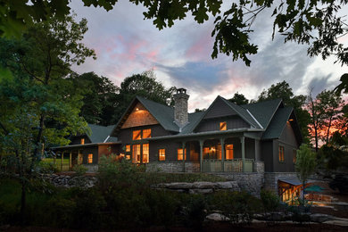 Large arts and crafts brown two-story wood gable roof photo in New York