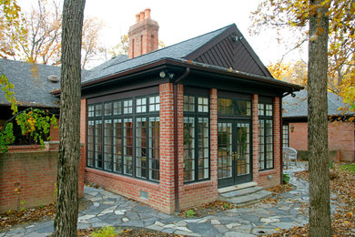 This is an example of a large traditional sunroom in Detroit with slate floors, a standard ceiling and grey floor.
